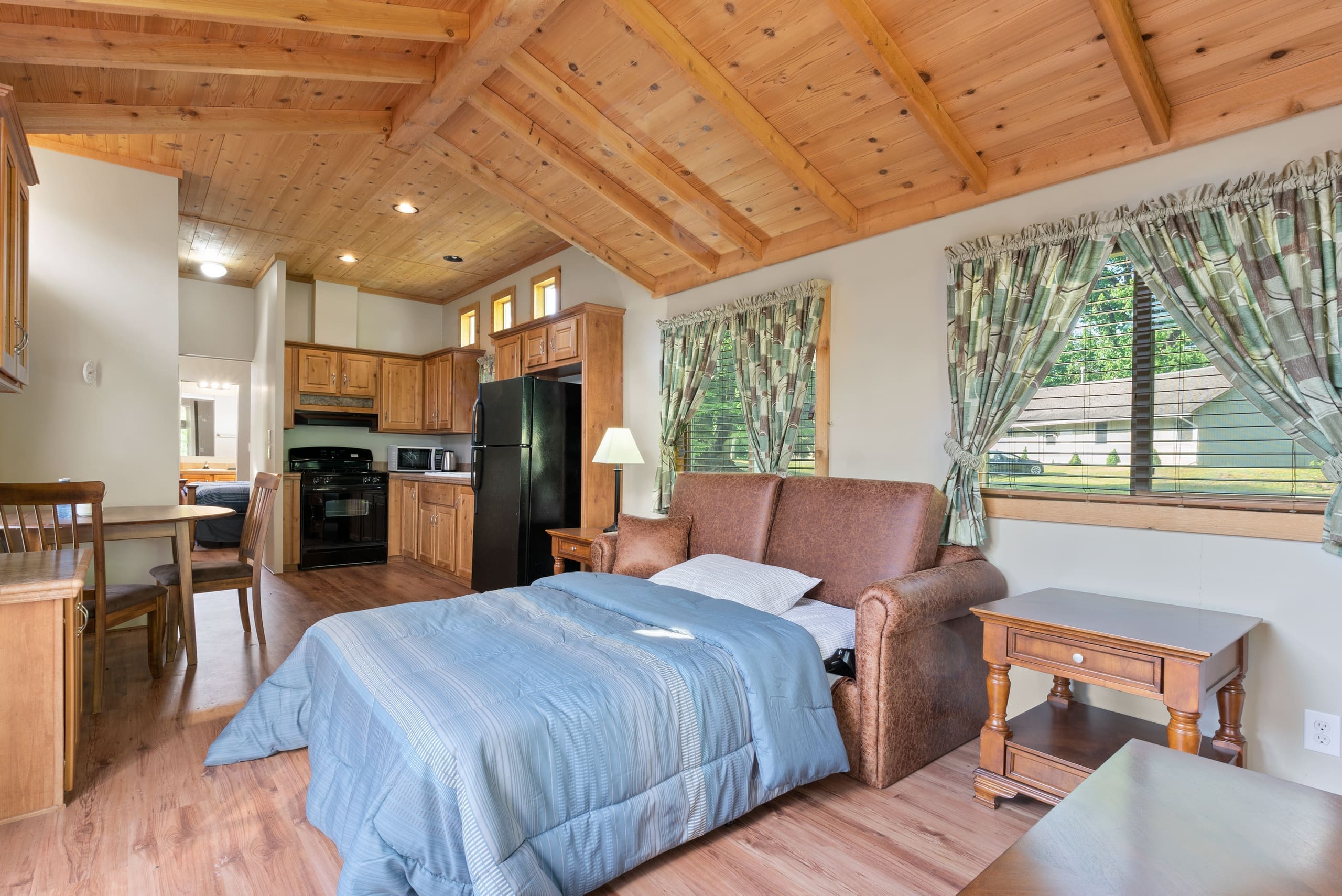 Cabin interior with sofa bed and vaulted cedar ceiling