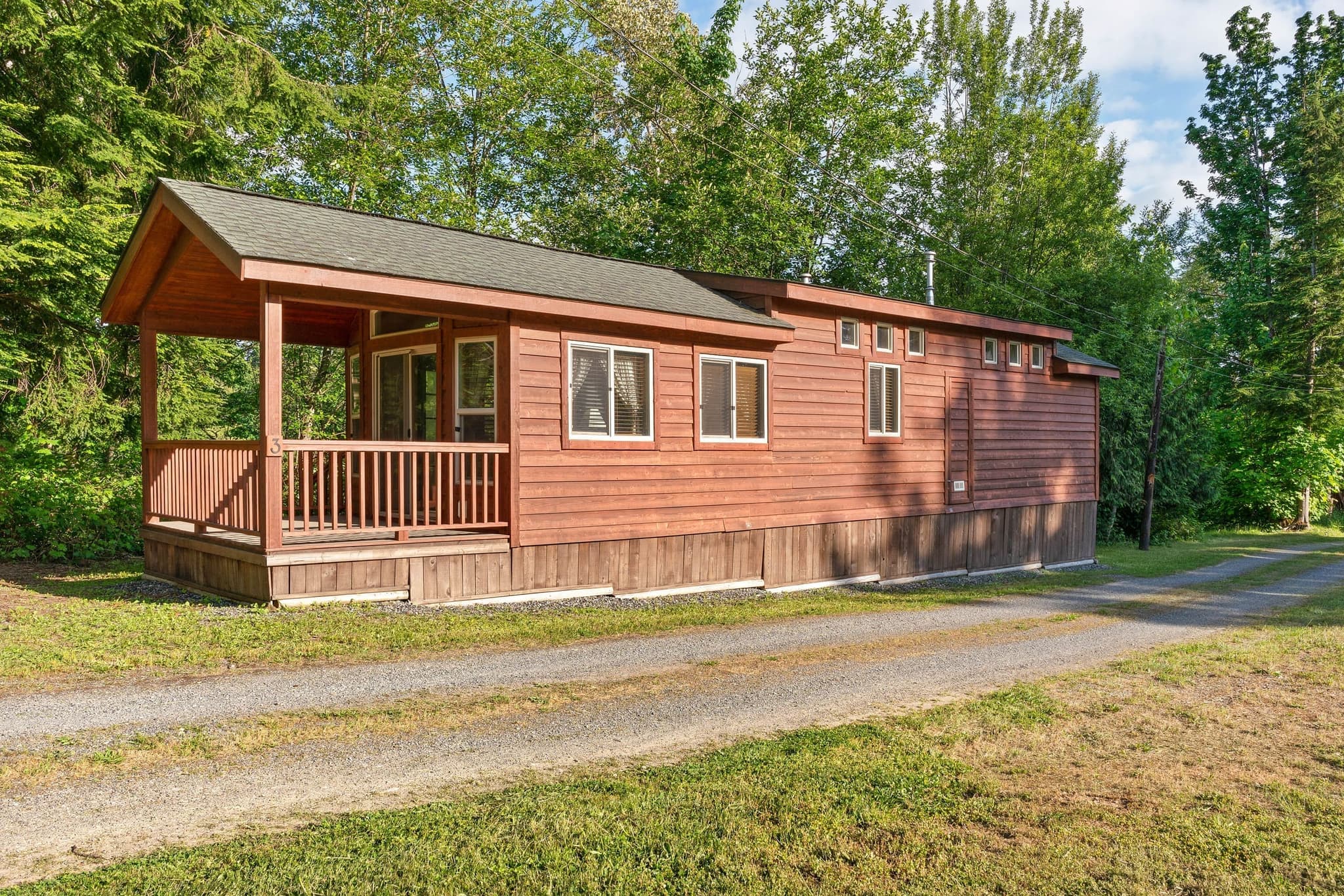 Red cedar deluxe cabin exterior with covered porch