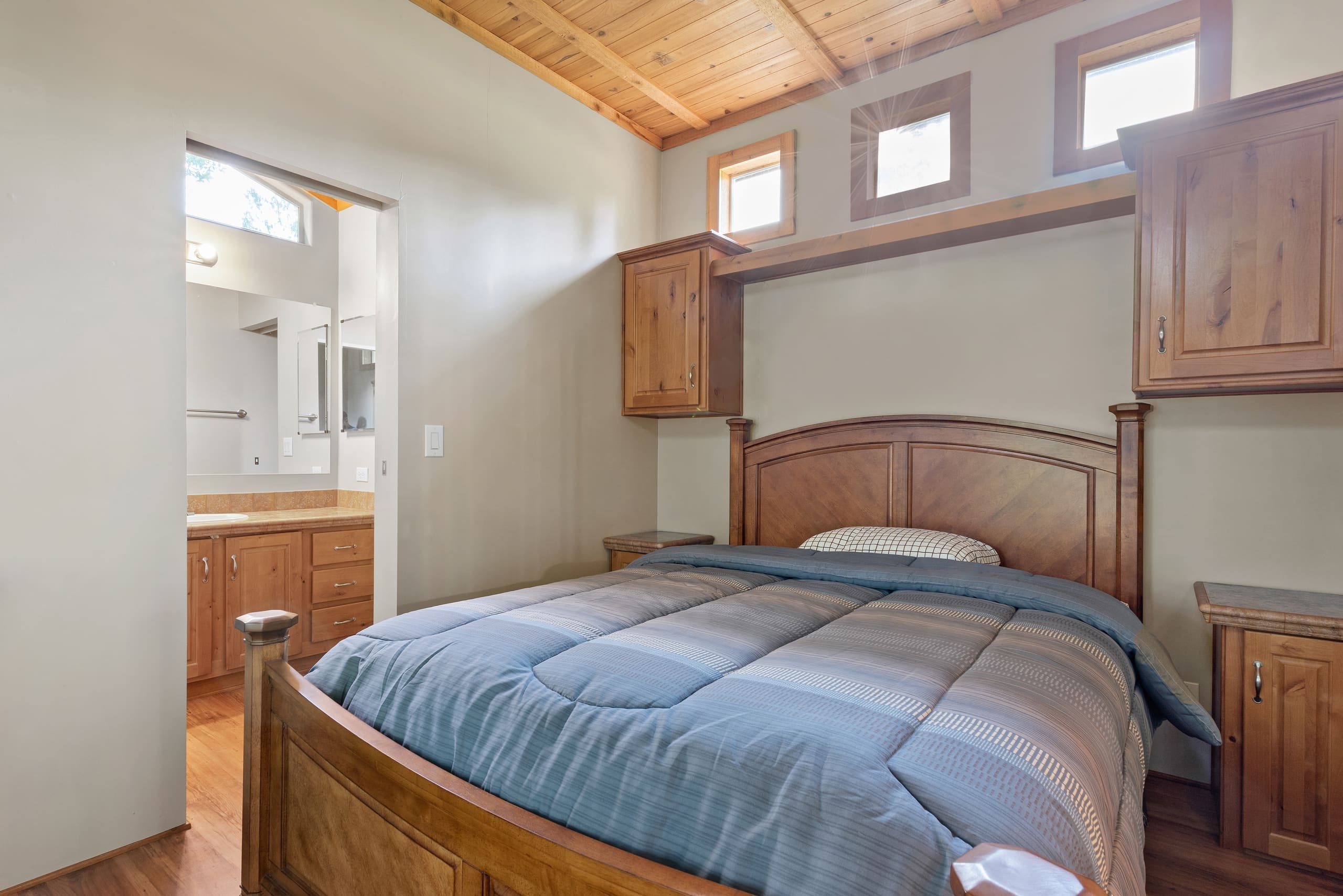 Cabin bedroom with built-in cabinetry and ensuite bathroom