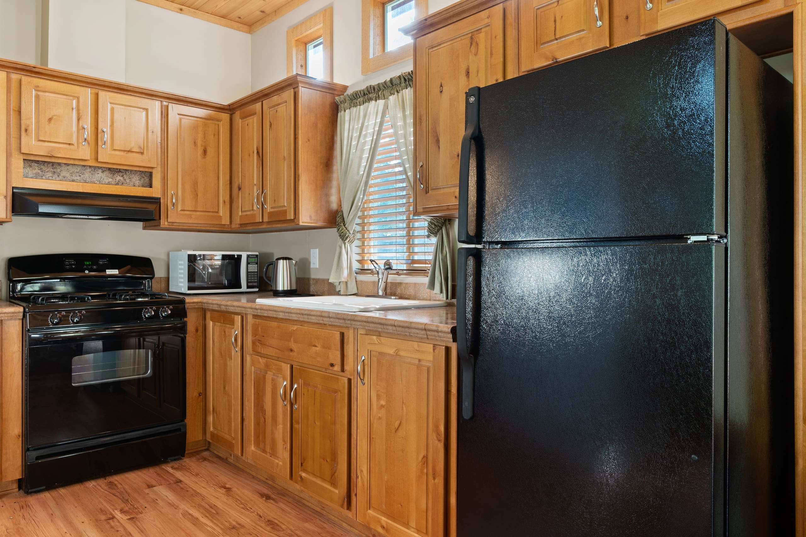 Fully equipped cabin kitchen with gas range and refrigerator