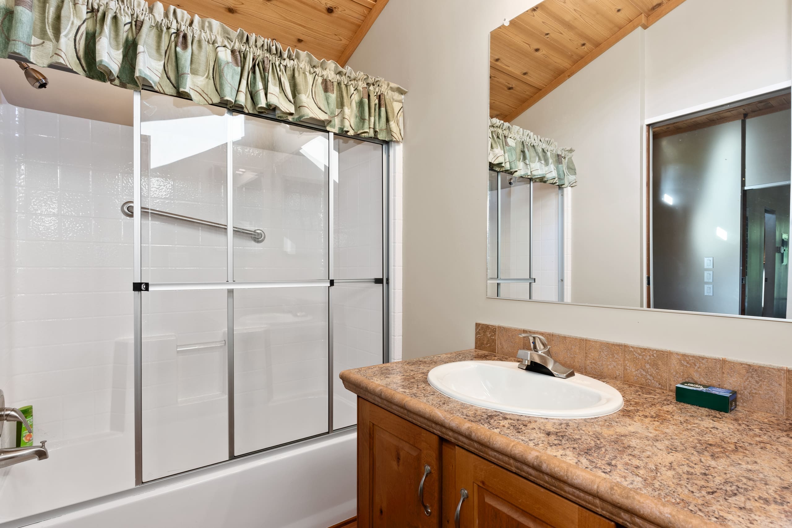 Cabin bathroom with glass shower and vanity