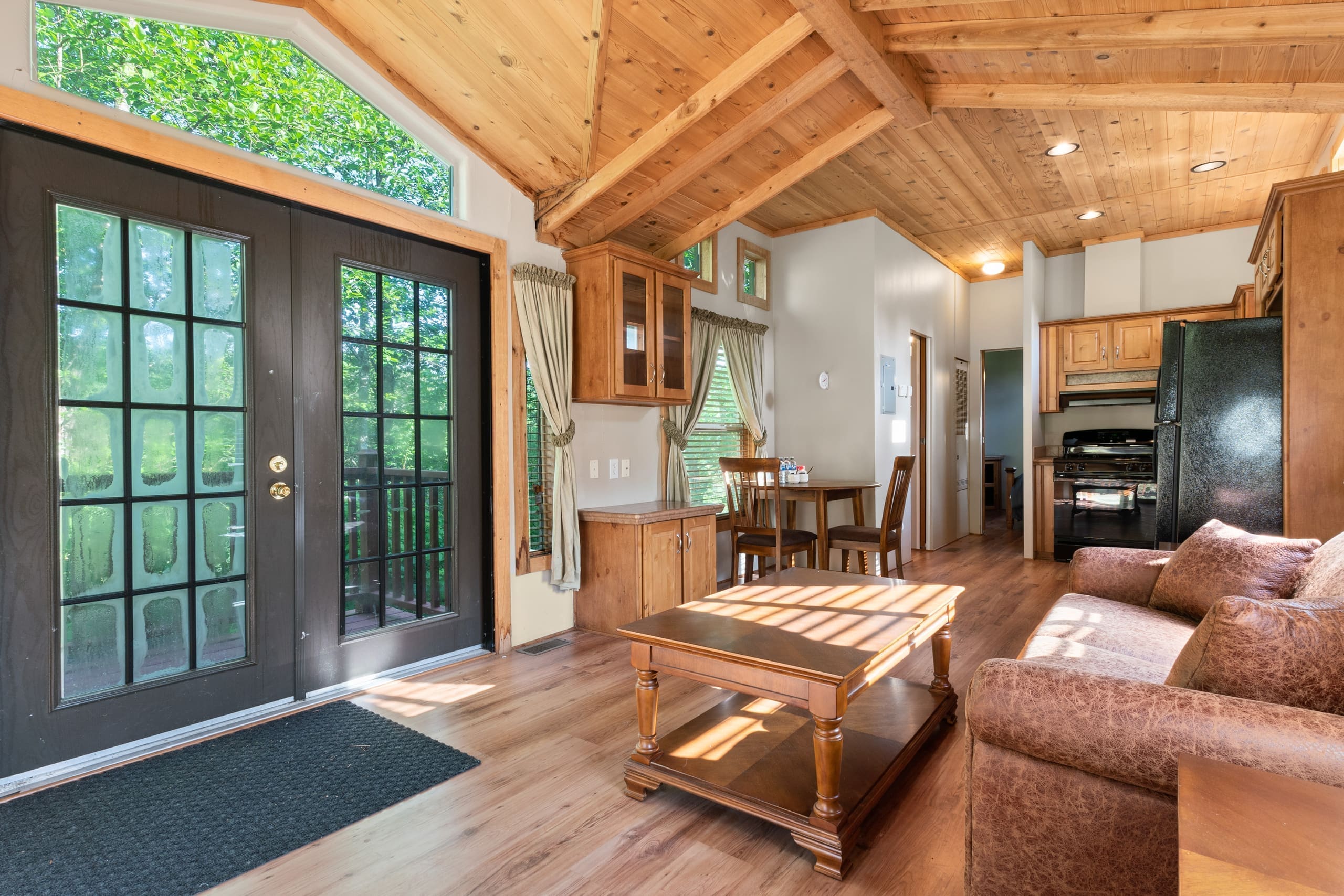 Cabin living area with french doors and picture windows