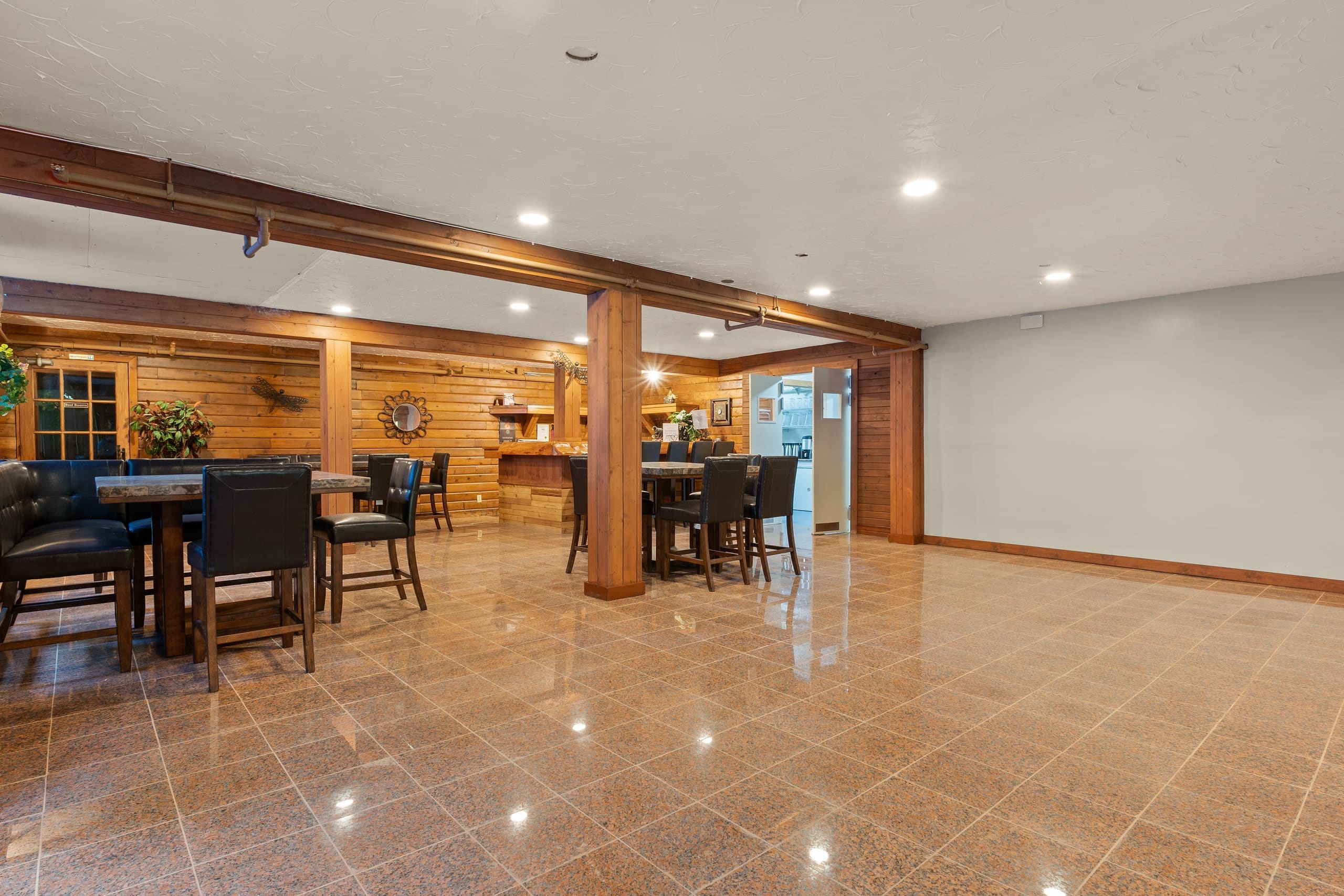 Lounge with granite floors, high tables, and bar seating