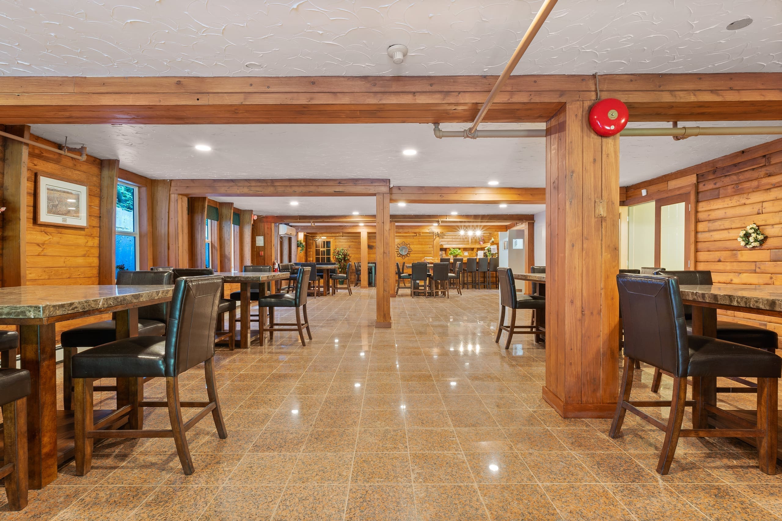 Pub-style lounge with marble-top tables and leather chairs