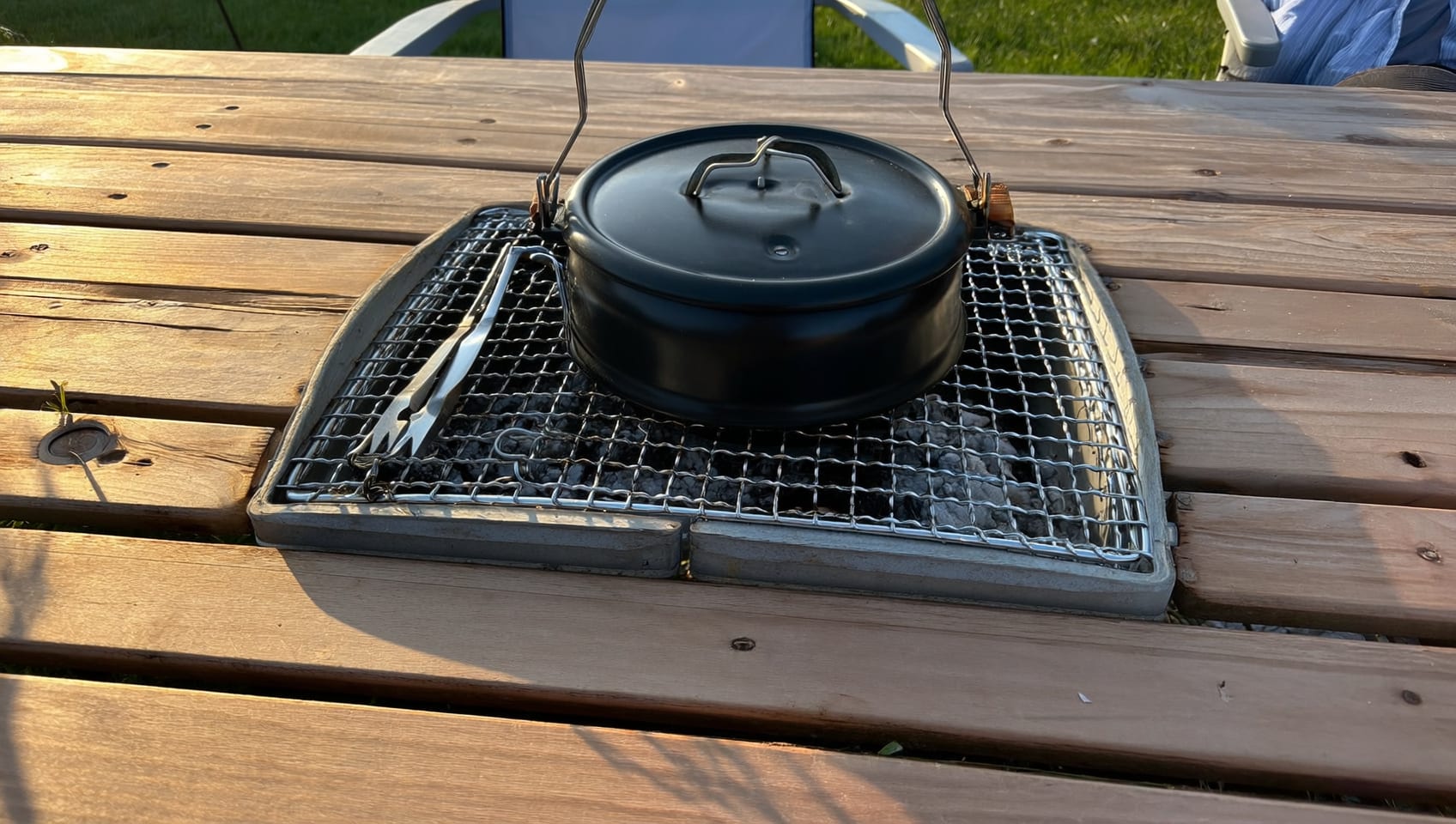 Close-up of the charcoal kettle grill and barbecue tool set at a glamping site