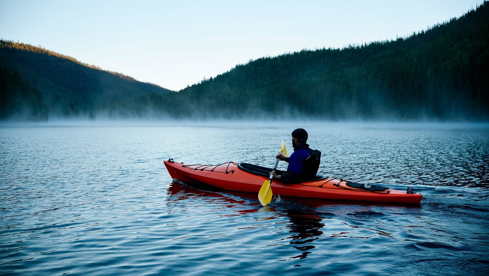 Kayak resting on a still lake at sunrise near the resort
